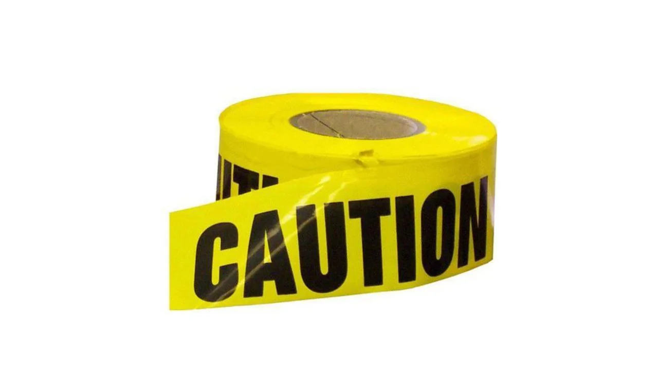 Yellow caution tape roll — job site safety marking
